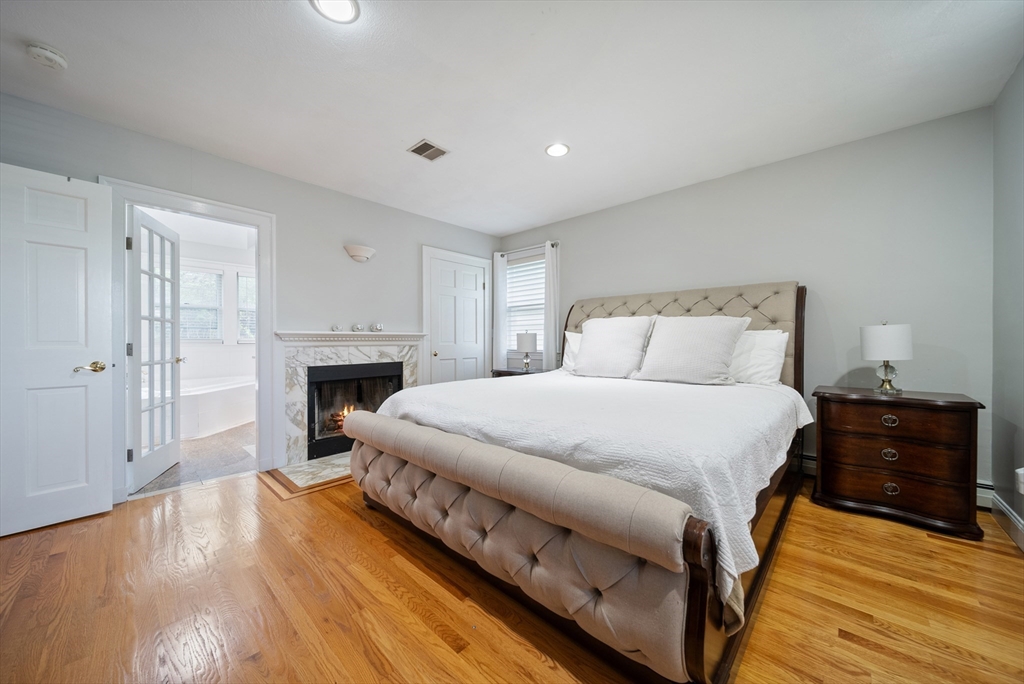 87 Hammersmith Drive Saugus, MA 01906 - Photo 24 of 37 a bedroom with a bed and a fireplace