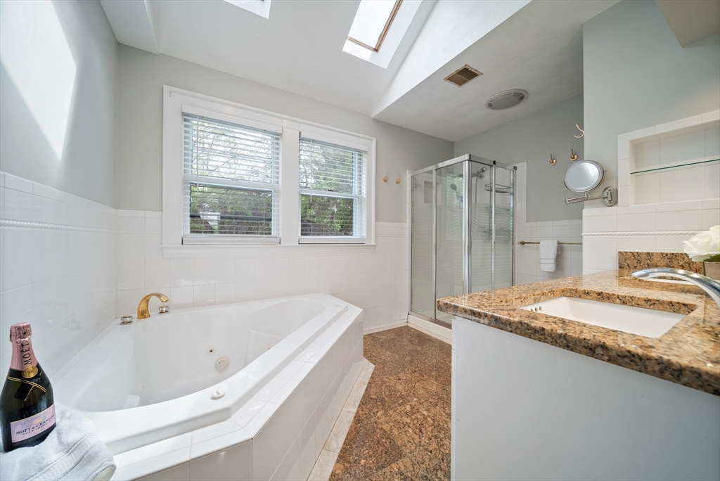 87 Hammersmith Drive Saugus, MA 01906 - Photo 26 of 37 a bathroom with a granite countertop tub sink and mirror