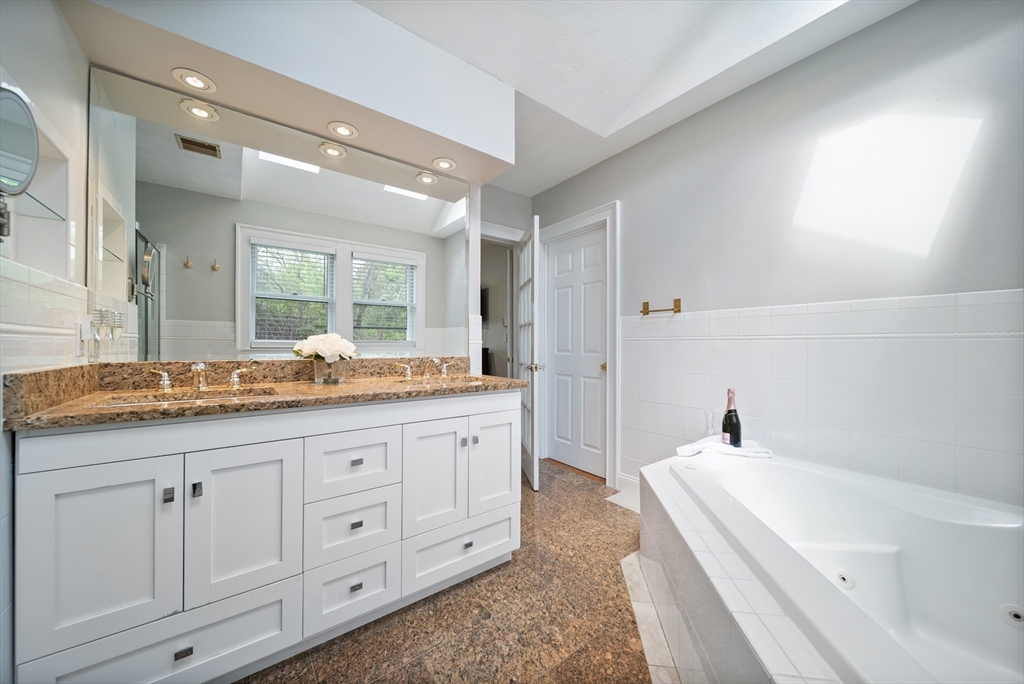 87 Hammersmith Drive Saugus, MA 01906 - Photo 28 of 37 a bathroom with a granite countertop double vanity sink a mirror and a bathtub