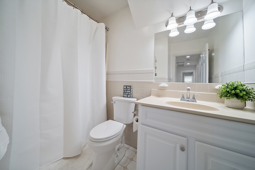 87 Hammersmith Drive Saugus, MA 01906 - Photo 32 of 37 a bathroom with a sink vanity mirror and toilet