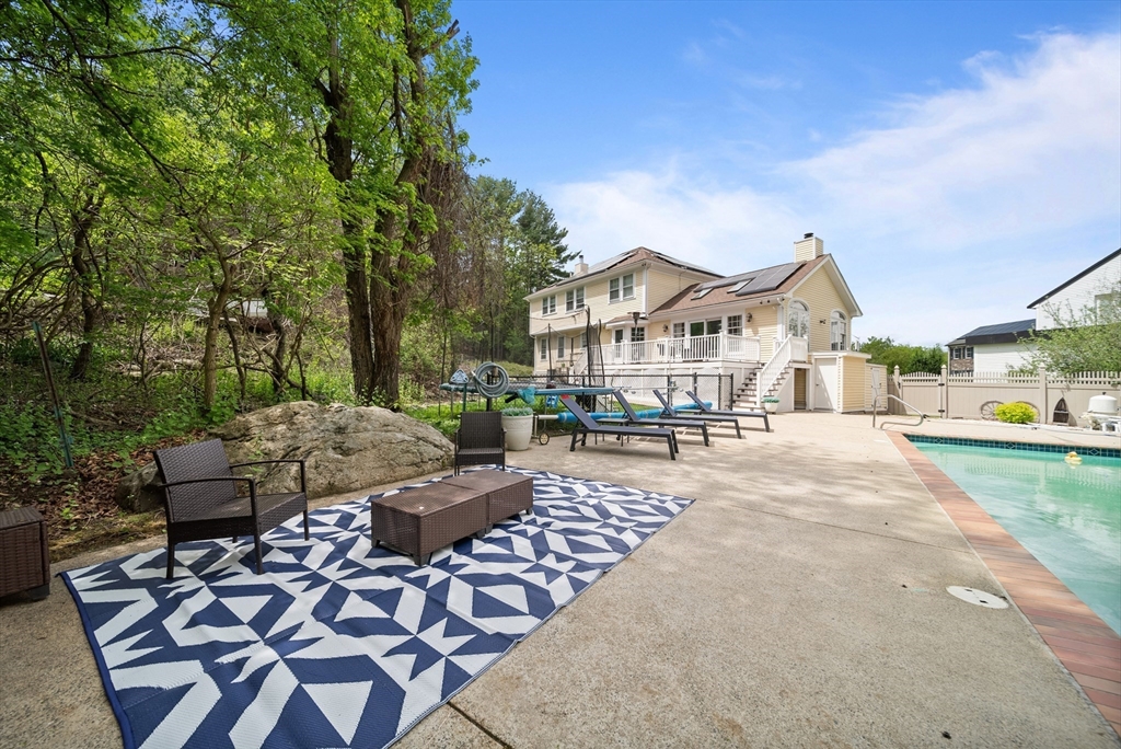 87 Hammersmith Drive Saugus, MA 01906 - Photo 4 of 37 a view of a town with couches and a fire pit