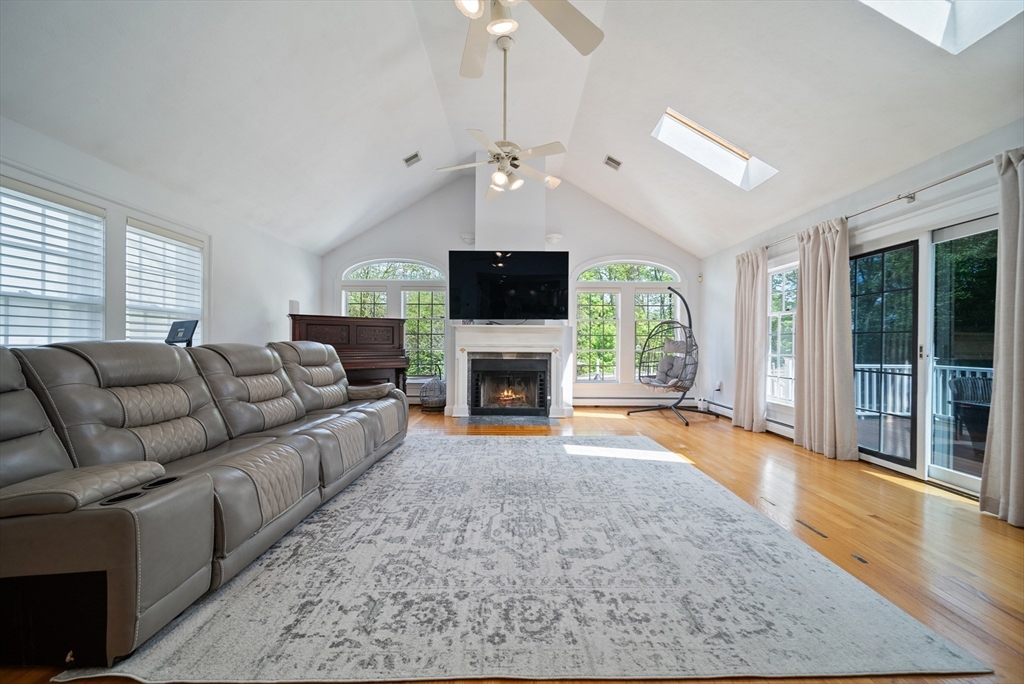 87 Hammersmith Drive Saugus, MA 01906 - Photo 5 of 37 a living room with furniture a fireplace and a flat screen tv