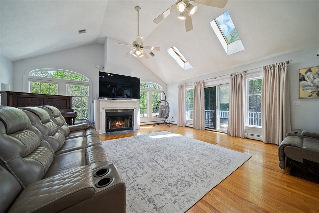 87 Hammersmith Drive Saugus, MA 01906 - Photo 6 of 37 a living room with furniture a flat screen tv and a fireplace