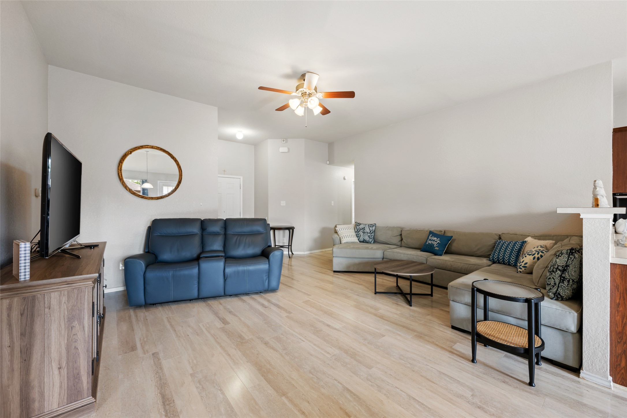 144 Calcite Lane Jarrell, TX 76537 - Photo 8 of 38 Luminous living space featuring light hardwood flooring and a functional ceiling fan.