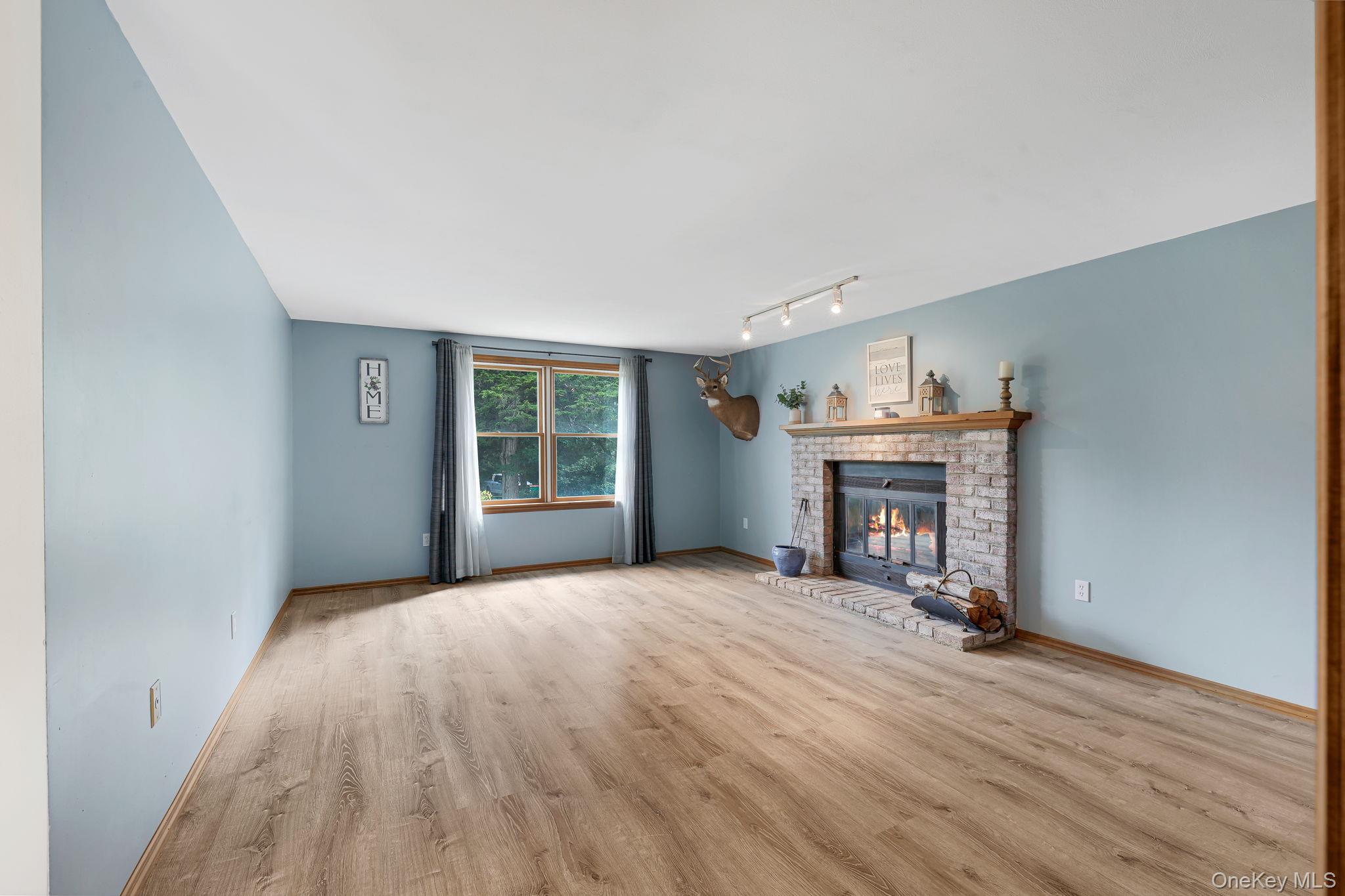 185 Rombout Road Pleasant Valley, NY 12569 - Photo 31 of 49 a view of an empty room with wooden floor fireplace and a window