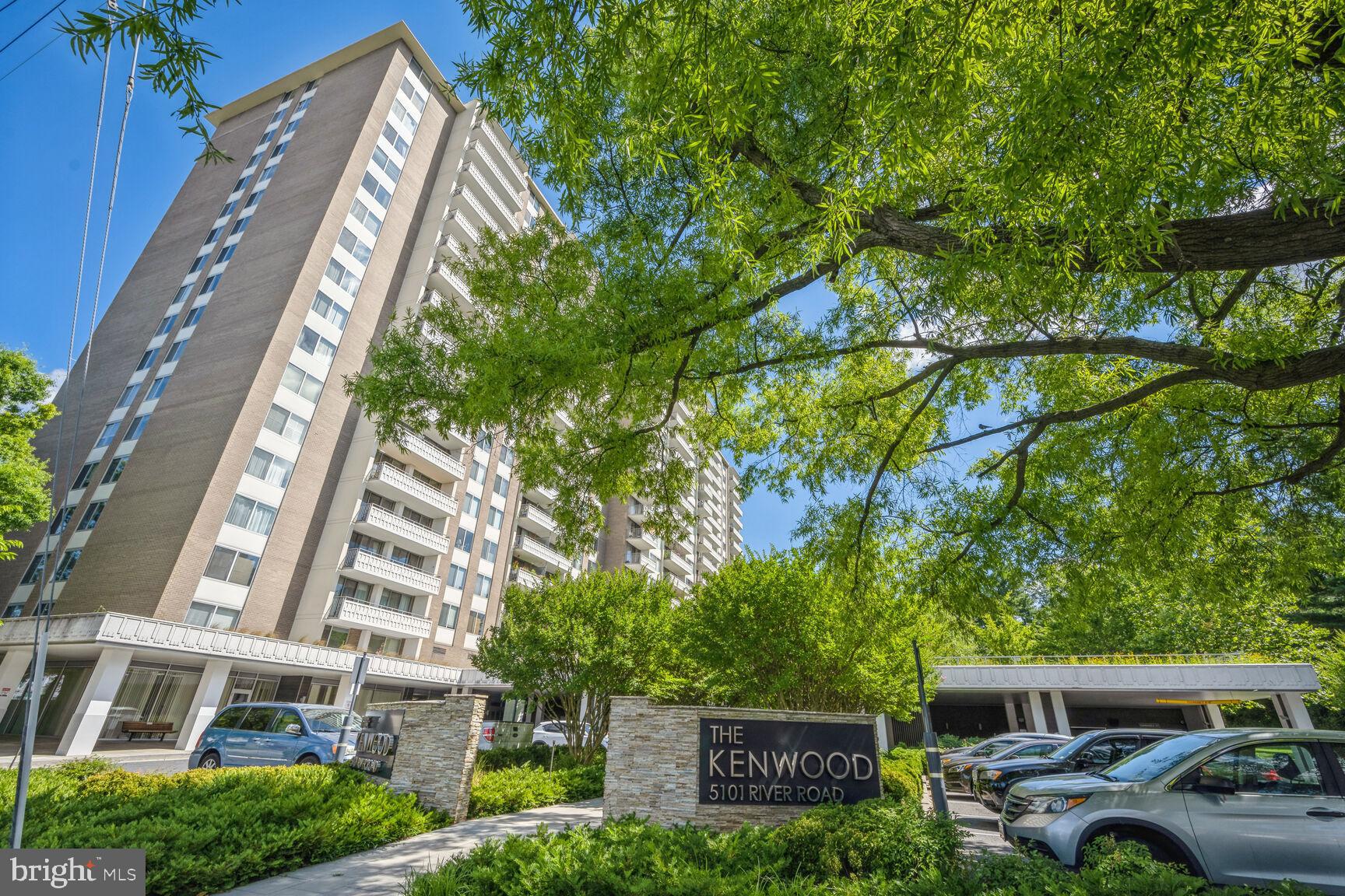 5101 River Road, Unit 405 Bethesda, MD 20816 - Photo 19 of 20 a front view of a building with plants and a trees