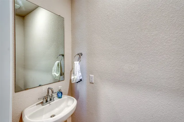 a bathroom with a sink and mirror