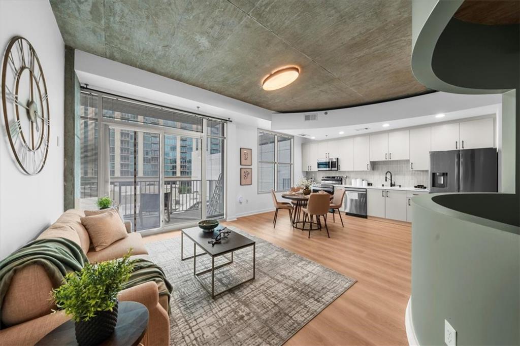 250 Pharr Road Northeast, Unit 704 Atlanta, GA 30305 - Photo 11 of 53 a living room with furniture and a large window