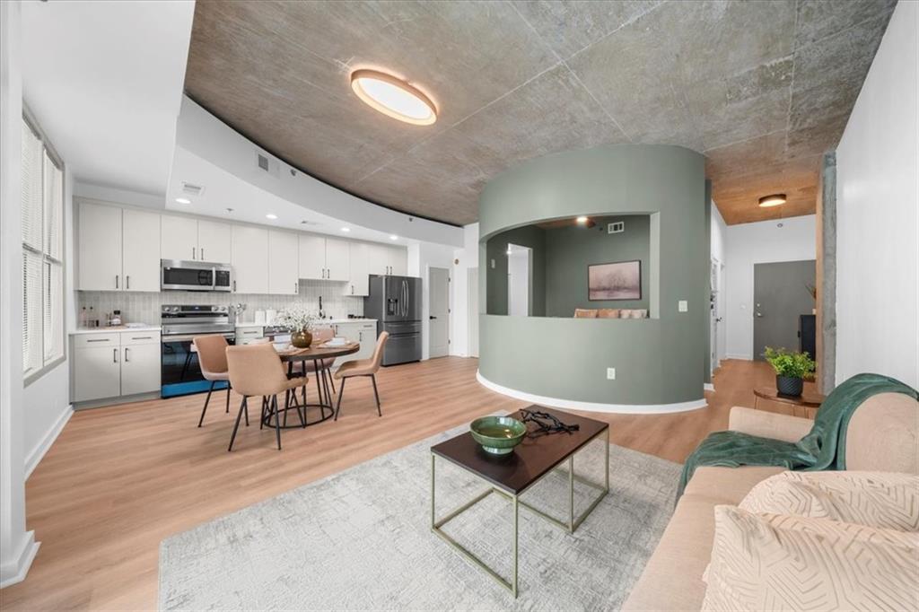 250 Pharr Road Northeast, Unit 704 Atlanta, GA 30305 - Photo 18 of 53 a living room with lots of furniture and kitchen view