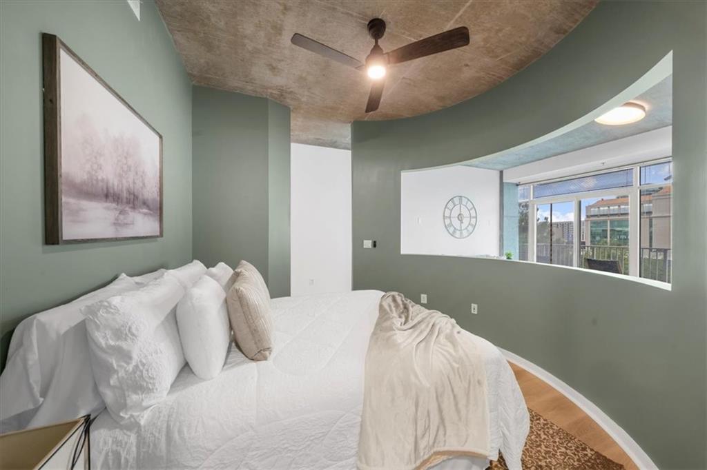 250 Pharr Road Northeast, Unit 704 Atlanta, GA 30305 - Photo 23 of 53 a bedroom with a large bed and a window