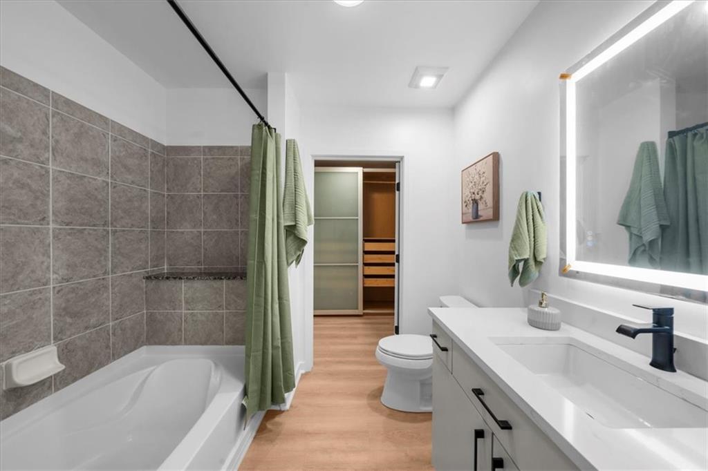 250 Pharr Road Northeast, Unit 704 Atlanta, GA 30305 - Photo 30 of 53 a bathroom with a bathtub sink and toilet