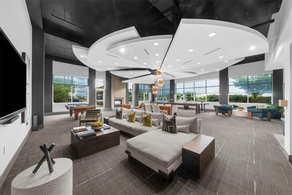 250 Pharr Road Northeast, Unit 704 Atlanta, GA 30305 - Photo 42 of 53 a living room with fireplace furniture and a large window