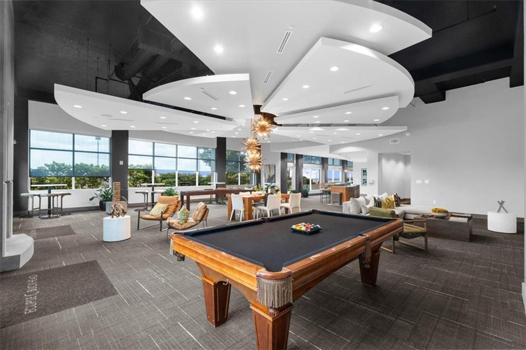 250 Pharr Road Northeast, Unit 704 Atlanta, GA 30305 - Photo 43 of 53 a living room with furniture a table and chairs