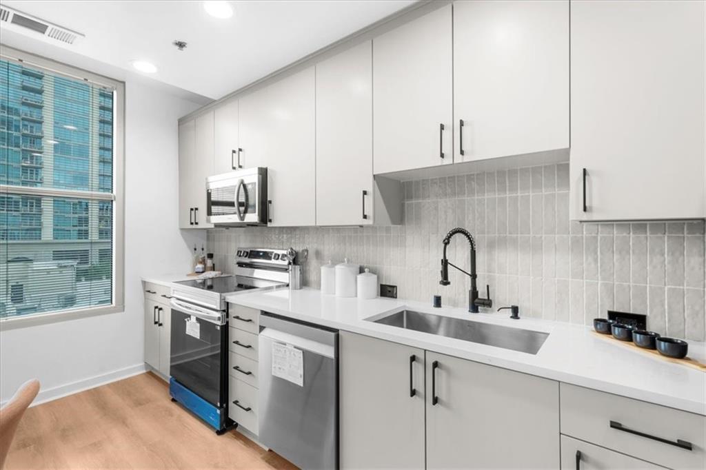250 Pharr Road Northeast, Unit 704 Atlanta, GA 30305 - Photo 7 of 53 a kitchen with a sink cabinets and window