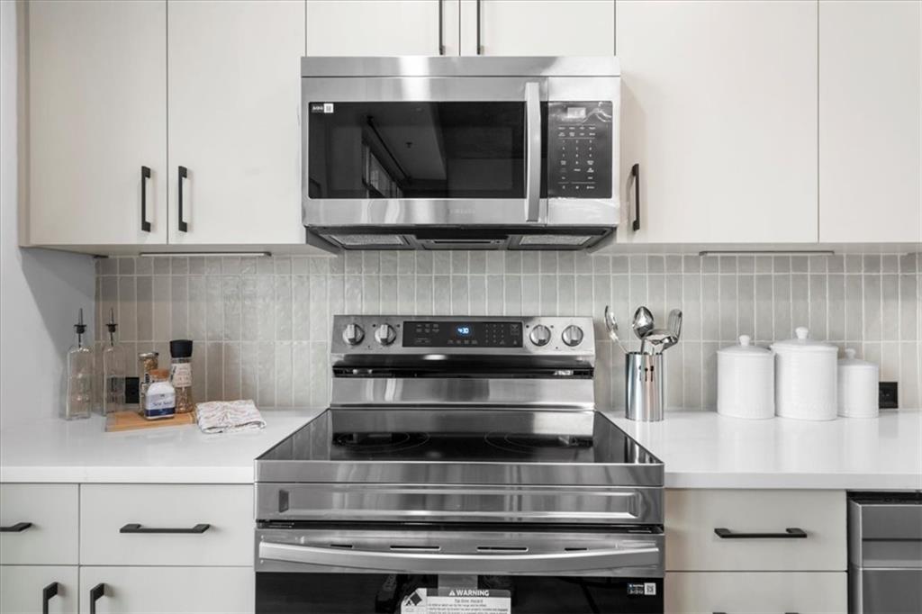 250 Pharr Road Northeast, Unit 704 Atlanta, GA 30305 - Photo 9 of 53 a stove top oven sitting inside of a kitchen