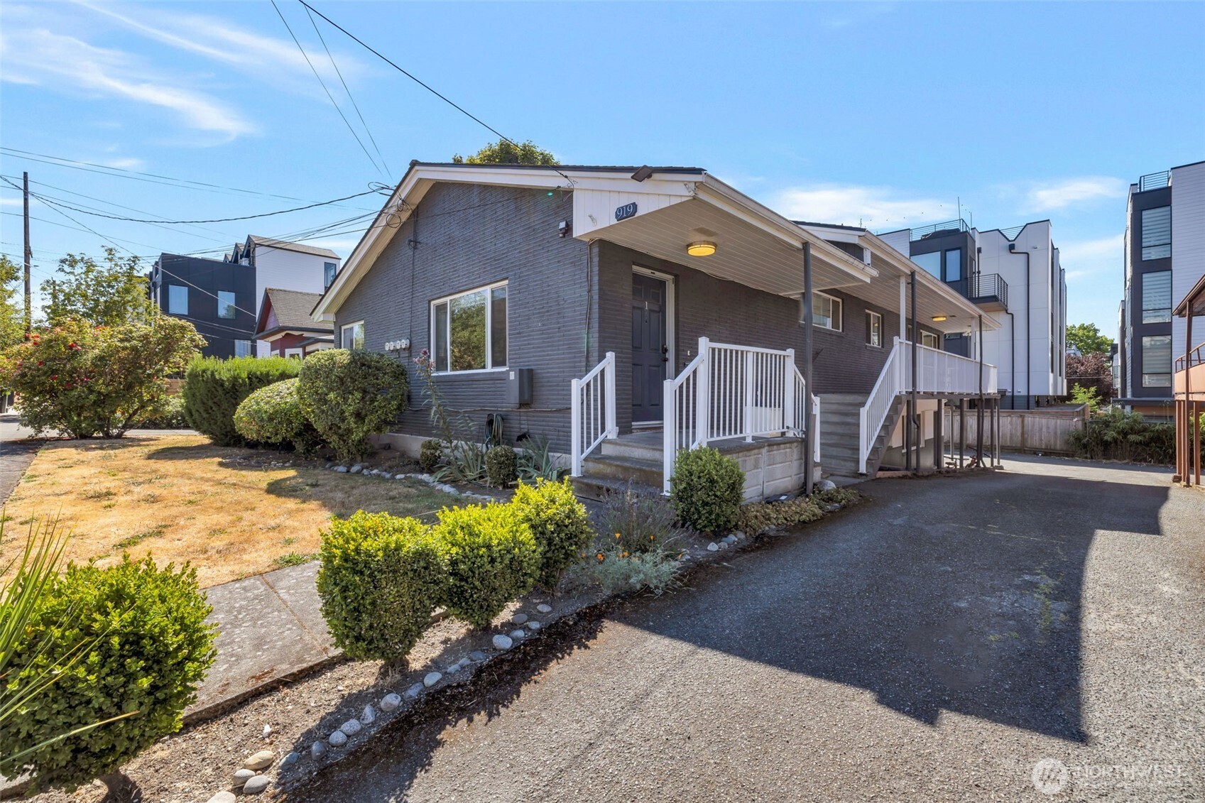 917 Northwest 57th Street Seattle, WA 98107 - Photo 4 of 23 a brick house with potted plants in front of it
