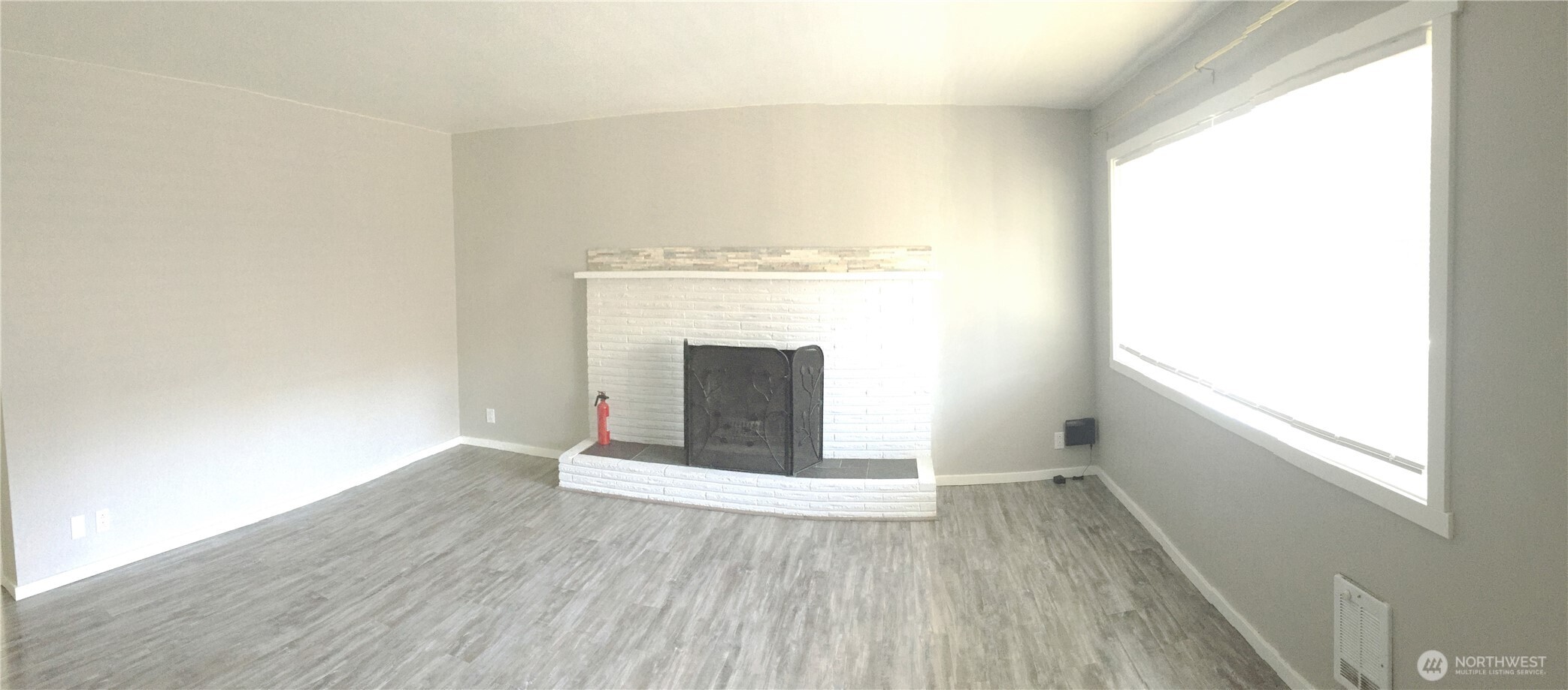 917 Northwest 57th Street Seattle, WA 98107 - Photo 10 of 23 a view of an empty room with wooden floor and a window