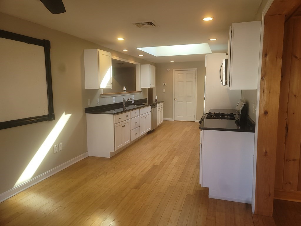 21 Kimball Road Amesbury, MA 01913 - Photo 17 of 23 a kitchen with granite countertop a stove and a refrigerator