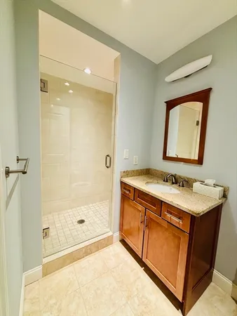 a bathroom with a sink a mirror and a shower