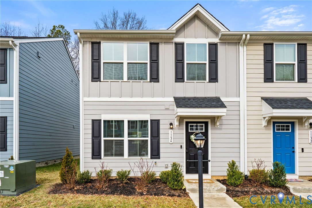 1136 Canterbury Ridge Road Richmond, VA 23224 - Photo 1 of 28 a front view of a house with plants and entryway