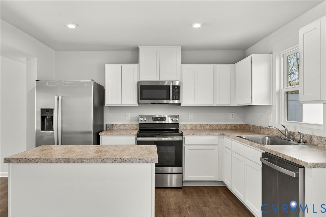 1136 Canterbury Ridge Road Richmond, VA 23224 - Photo 13 of 28 a kitchen with granite countertop white cabinets and stainless steel appliances