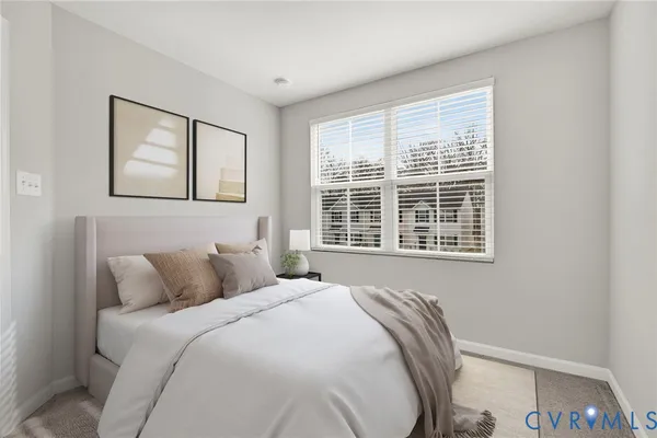 a bedroom with a bed and a large window