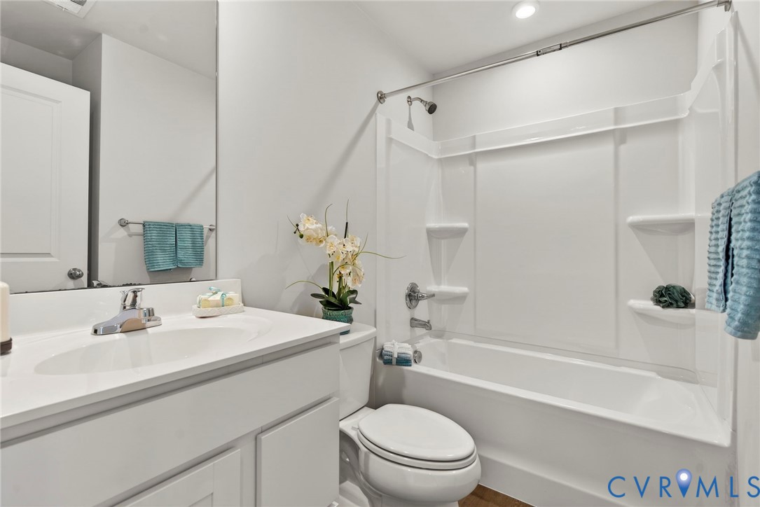 1136 Canterbury Ridge Road Richmond, VA 23224 - Photo 21 of 28 a bathroom with a sink toilet and shower