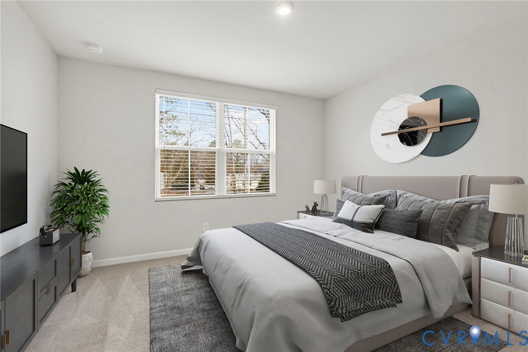 1136 Canterbury Ridge Road Richmond, VA 23224 - Photo 22 of 28 a bedroom with bed and a potted plant