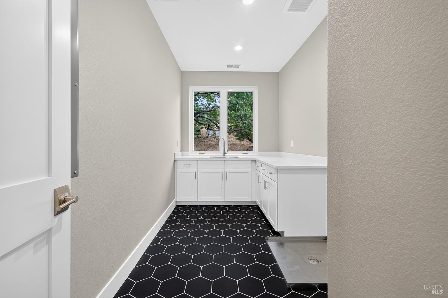 1913 Carlile Place Santa Rosa, CA 95403 - Photo 41 of 60 Here is the large laundry room, that offers lower cabinets and a sink. Notice the decorative tile floor.