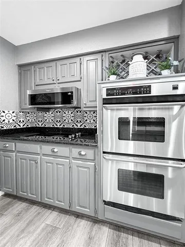 a kitchen with stainless steel appliances granite countertop a stove oven and a refrigerator