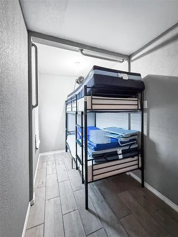 a view of hallway with wooden floor