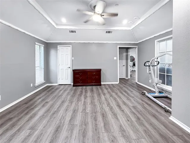 a kitchen with white cabinets and refrigerator