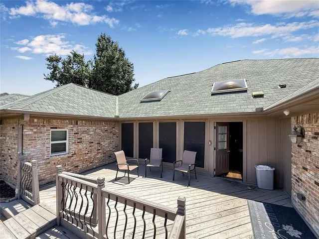 a view of a patio with a table chairs and a fire pit