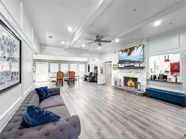 a living room with hardwood floor furniture and a window