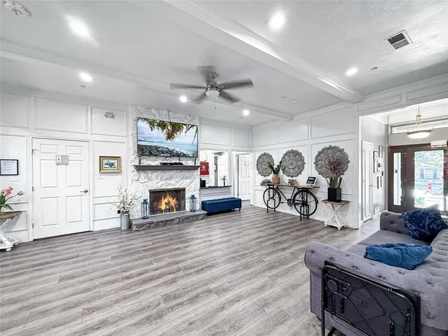 a living room with furniture and wooden floor