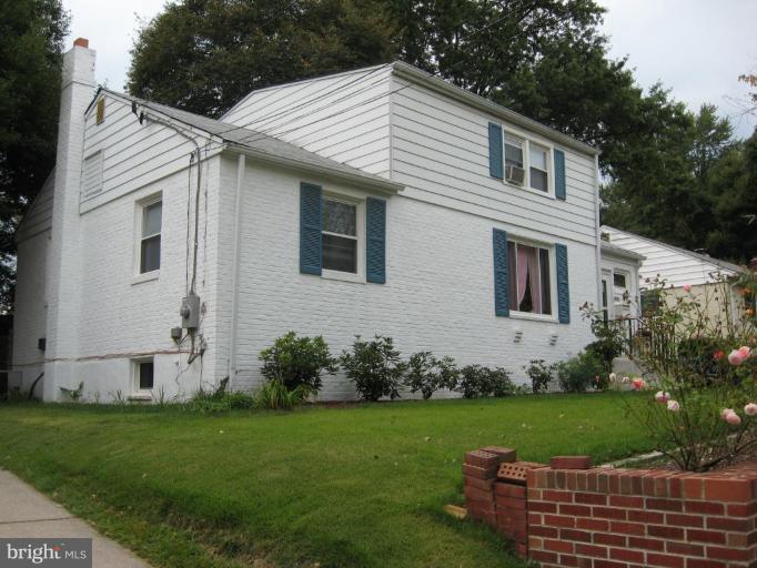 12404 Goodhill Road Silver Spring, MD 20906 - Photo 1 of 1 a front view of a house with a garden