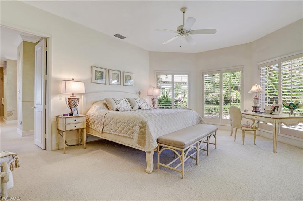 4588 Silver Fox Drive Naples, FL 34119 - Photo 17 of 35 a bedroom with a bed and a table chair in it