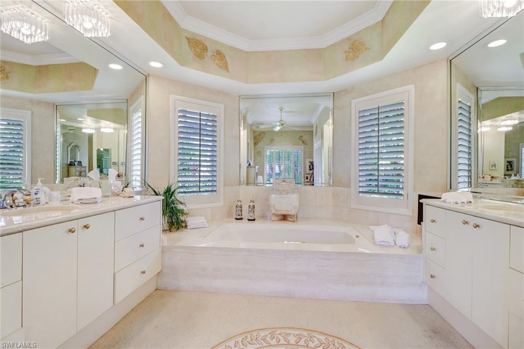 4588 Silver Fox Drive Naples, FL 34119 - Photo 18 of 35 a spacious bathroom with sinks mirror and a bathtub