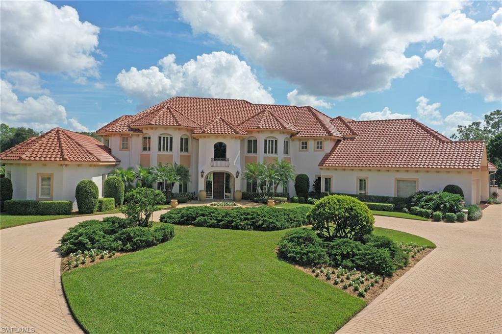 4588 Silver Fox Drive Naples, FL 34119 - Photo 2 of 35 a front view of a house with a yard