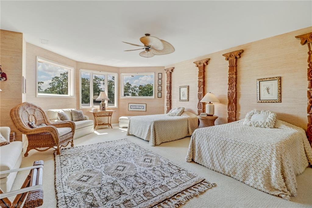 4588 Silver Fox Drive Naples, FL 34119 - Photo 21 of 35 a bedroom with a large bed and a couch