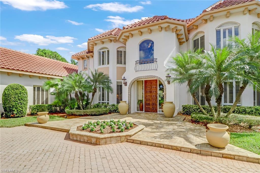 4588 Silver Fox Drive Naples, FL 34119 - Photo 3 of 35 a front view of a house with garden