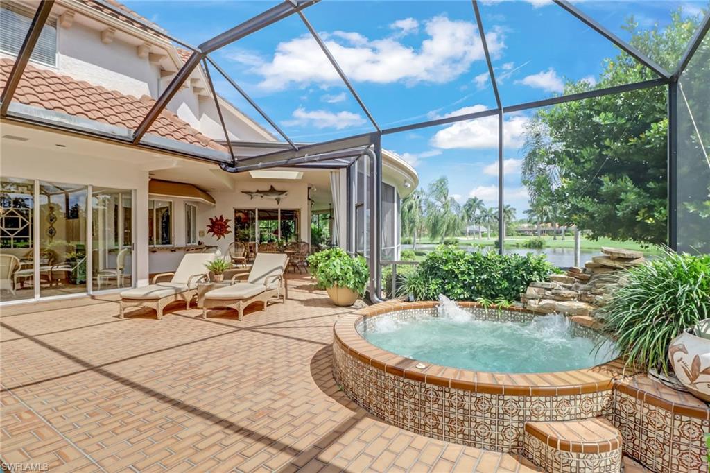 4588 Silver Fox Drive Naples, FL 34119 - Photo 31 of 35 a view of a house with backyard sitting area and tub