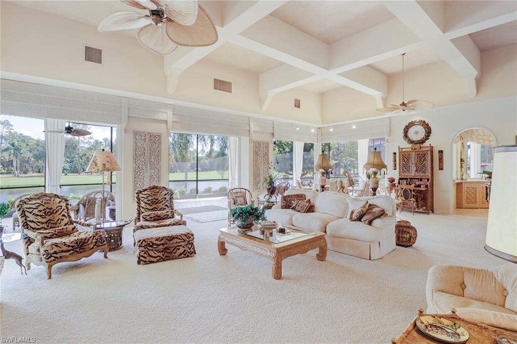 4588 Silver Fox Drive Naples, FL 34119 - Photo 4 of 35 a living room with furniture and a large window with garden view
