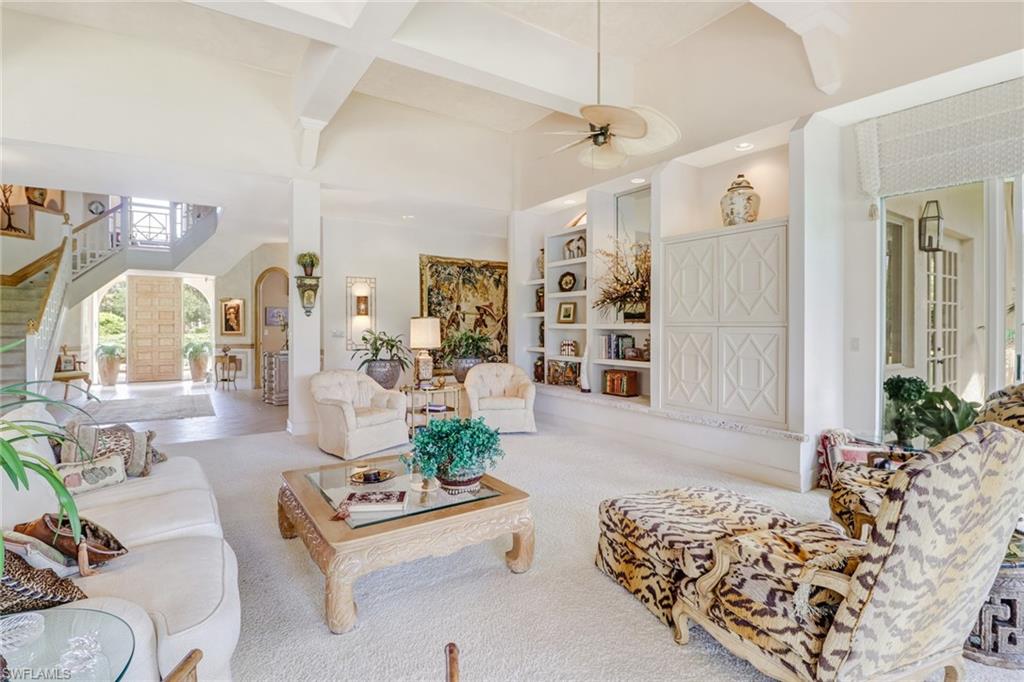 4588 Silver Fox Drive Naples, FL 34119 - Photo 6 of 35 a living room with furniture potted plant and a chandelier