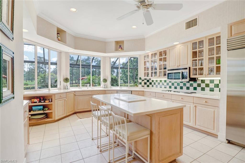 4588 Silver Fox Drive Naples, FL 34119 - Photo 9 of 35 a view of a kitchen counter space with furniture and windows