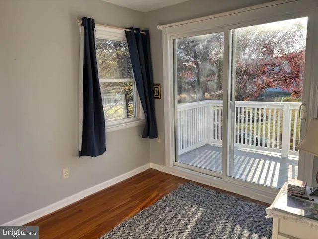 a view of a room with wooden floor and a window