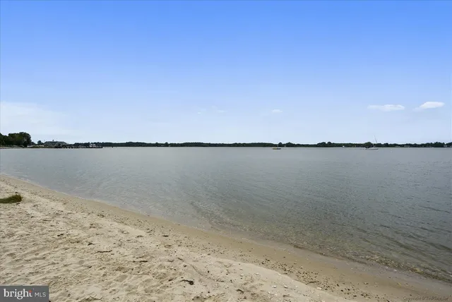 a view of a lake with beach in background