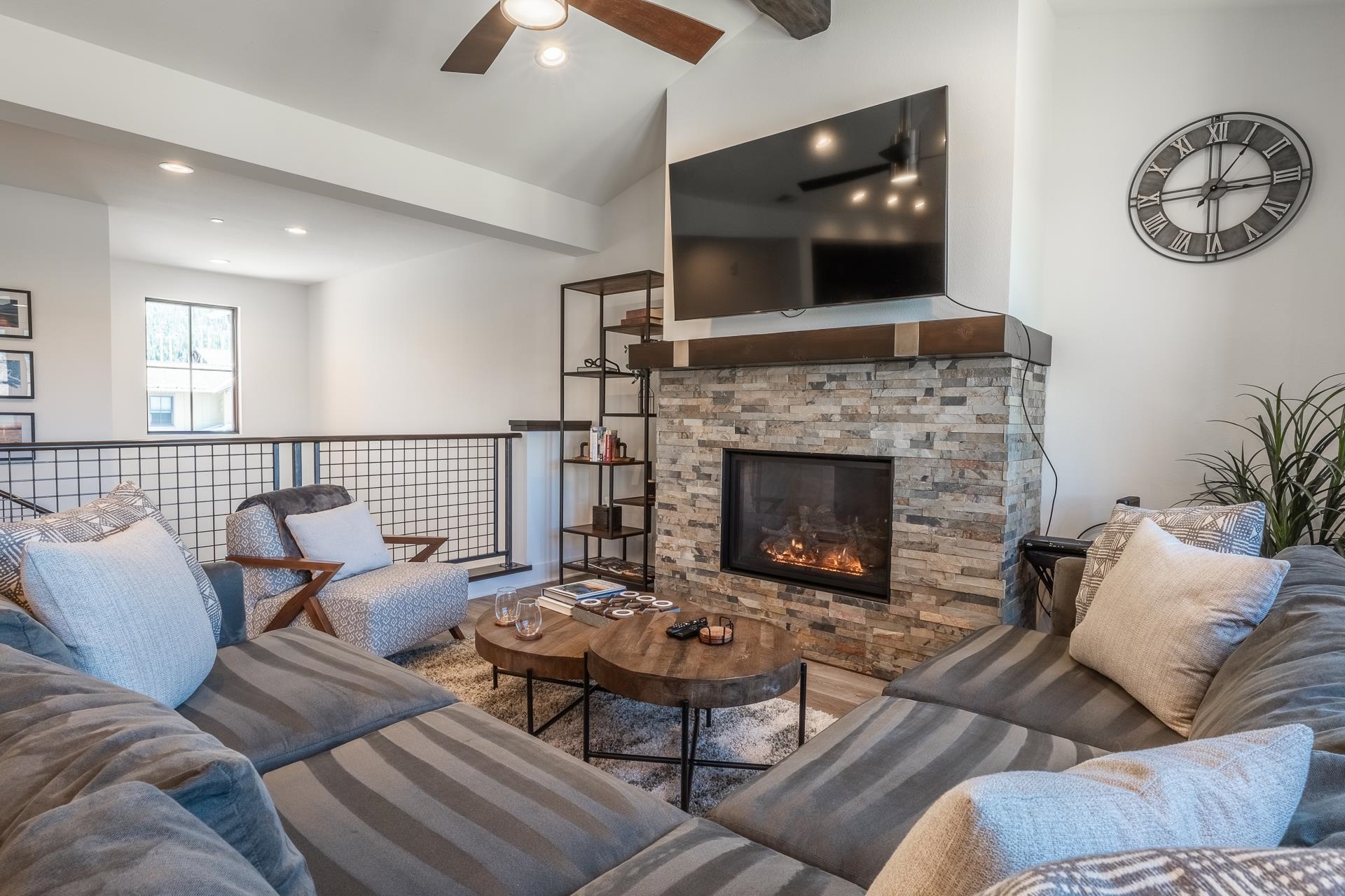 1353 Timber Creek Road, Unit 1353 Mammoth Lakes, CA 93546 - Photo 5 of 50 a living room with furniture a flat screen tv and a fireplace