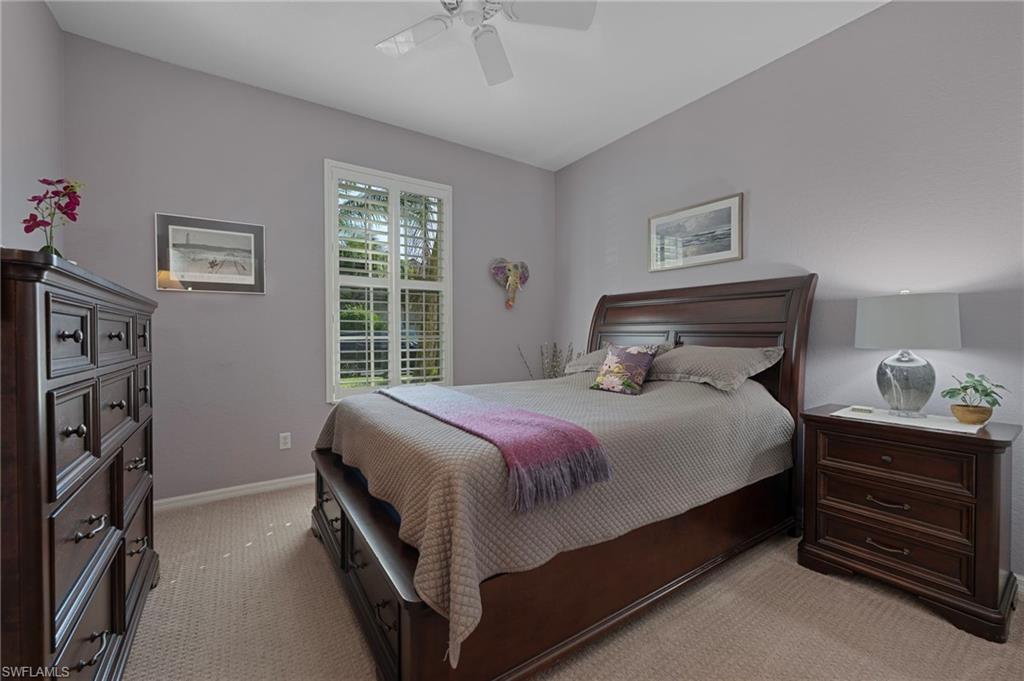4695 Winged Foot Court, Unit 101 Naples, FL 34112 - Photo 11 of 23 a bedroom with a bed and a window