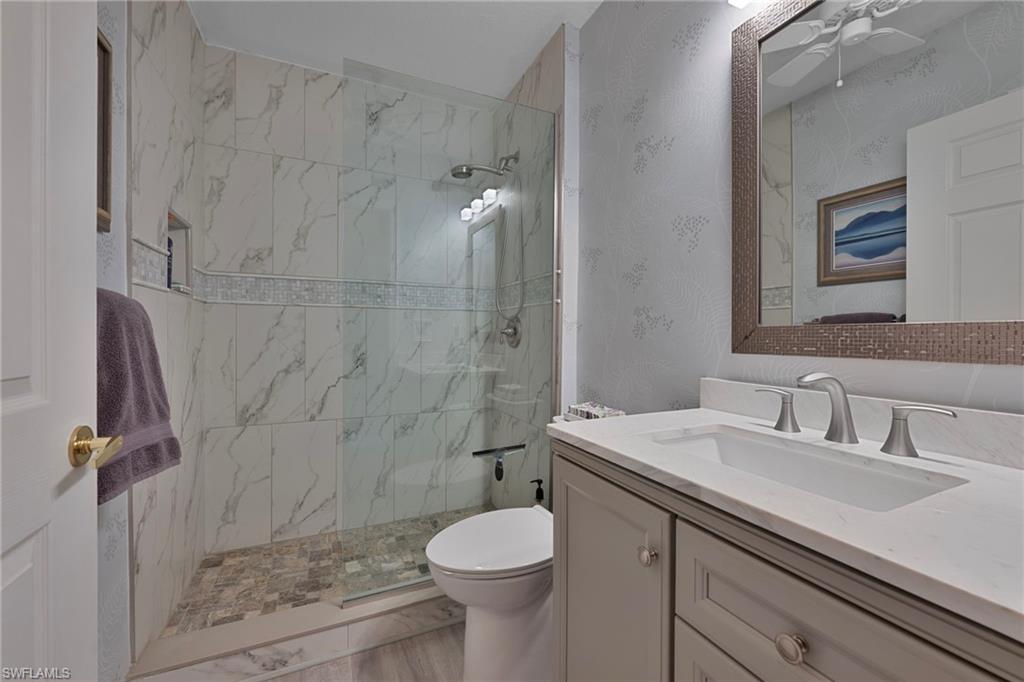 4695 Winged Foot Court, Unit 101 Naples, FL 34112 - Photo 13 of 23 a bathroom with a sink toilet and shower